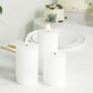 White LED flameless pillar candles with ribbed design on a table.