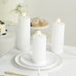 White LED flameless pillar candles with ribbed design on a table.