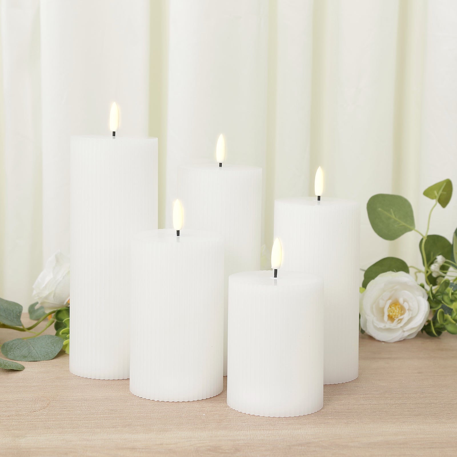 White LED flameless pillar candles in ribbed design, set of 5.
