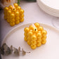 Metallic gold LED mini bubble candles on a plate.