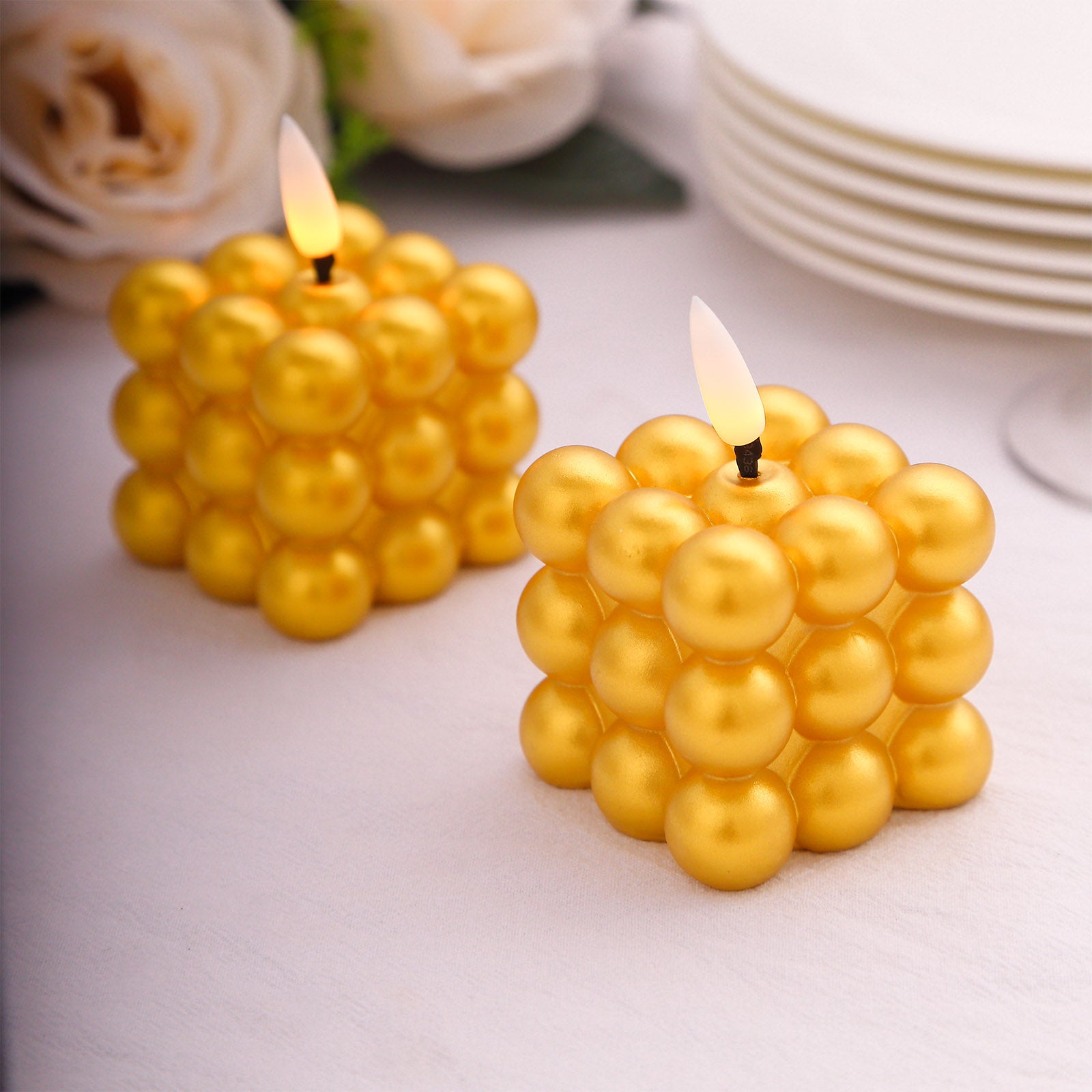 Metallic gold LED mini bubble candles in a cube shape.