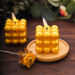 Metallic gold LED mini bubble candles on a wooden tray.