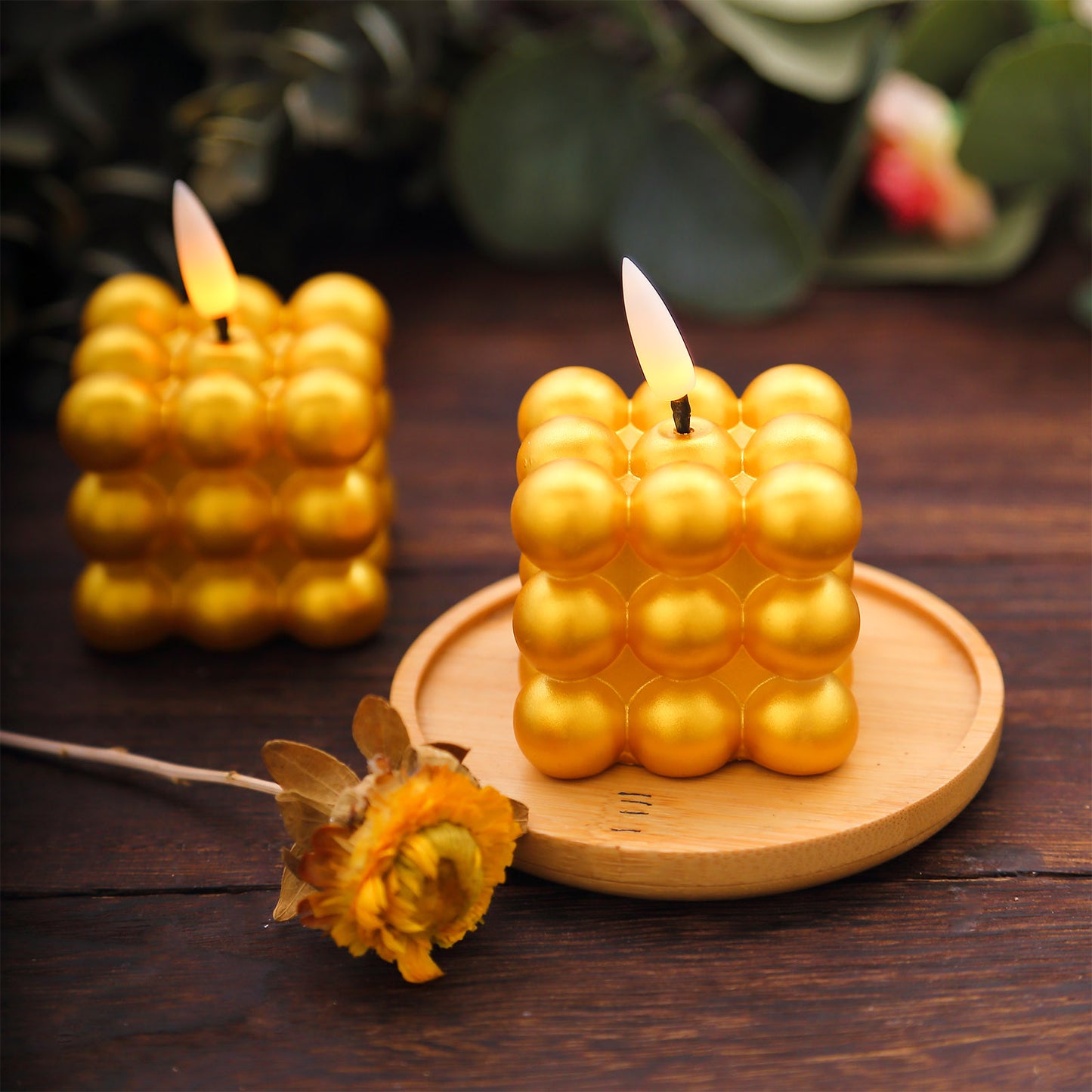 Metallic gold LED mini bubble candles on a wooden tray.