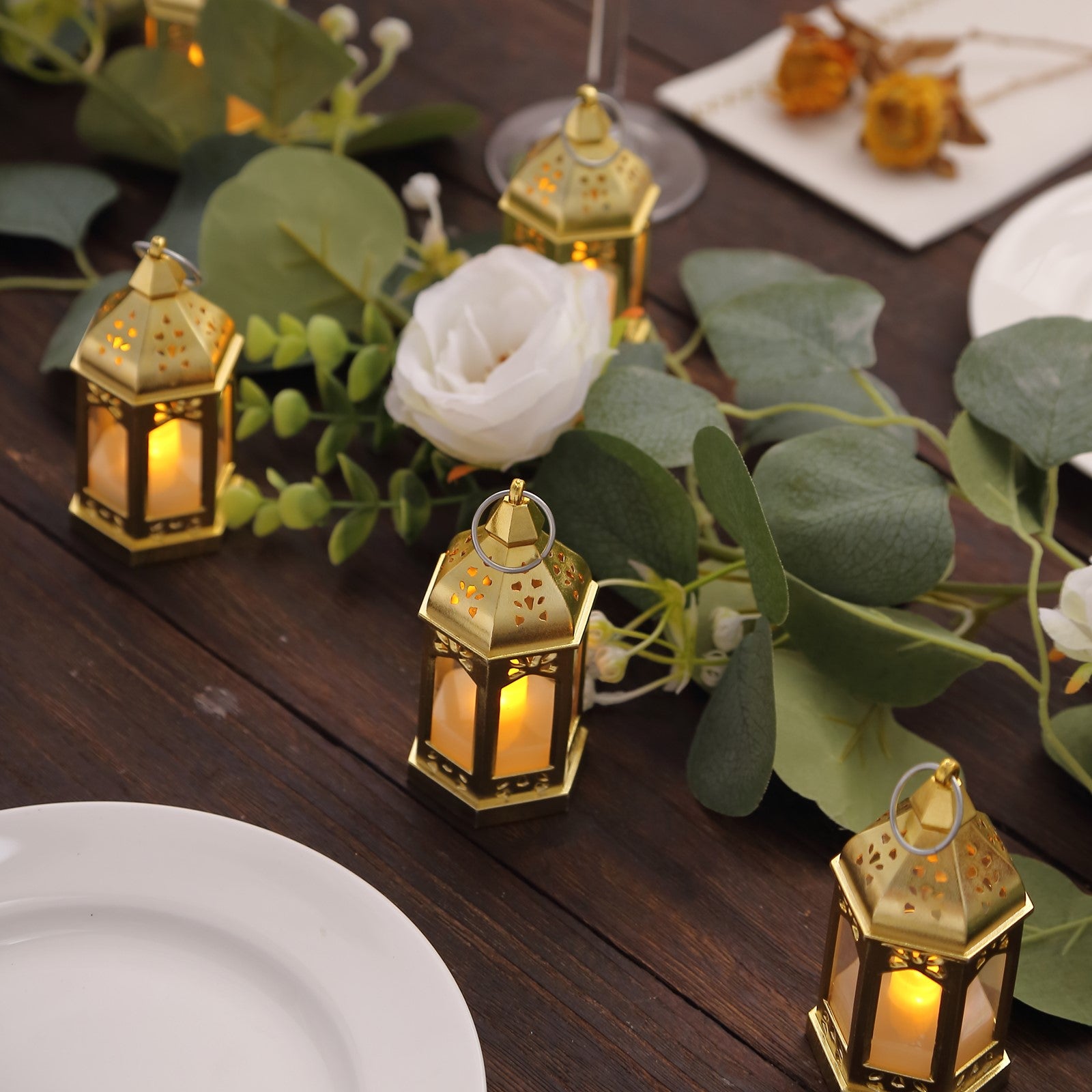Gold vintage mini LED lanterns with warm white flickering light, perfect for centerpieces.