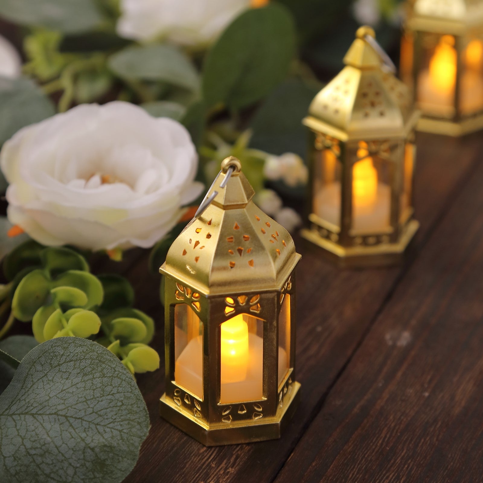 Gold vintage mini LED lanterns with warm white flickering light, perfect for centerpieces.