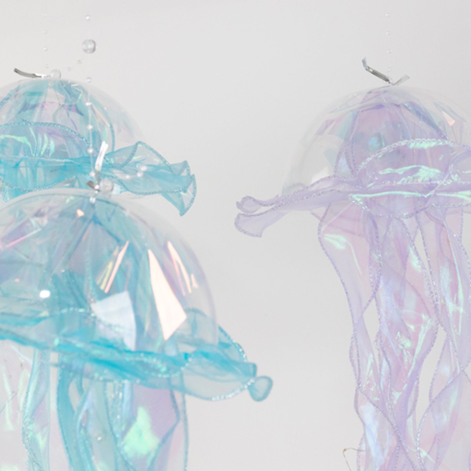 Blue and purple jellyfish lantern lights with organza ribbons.