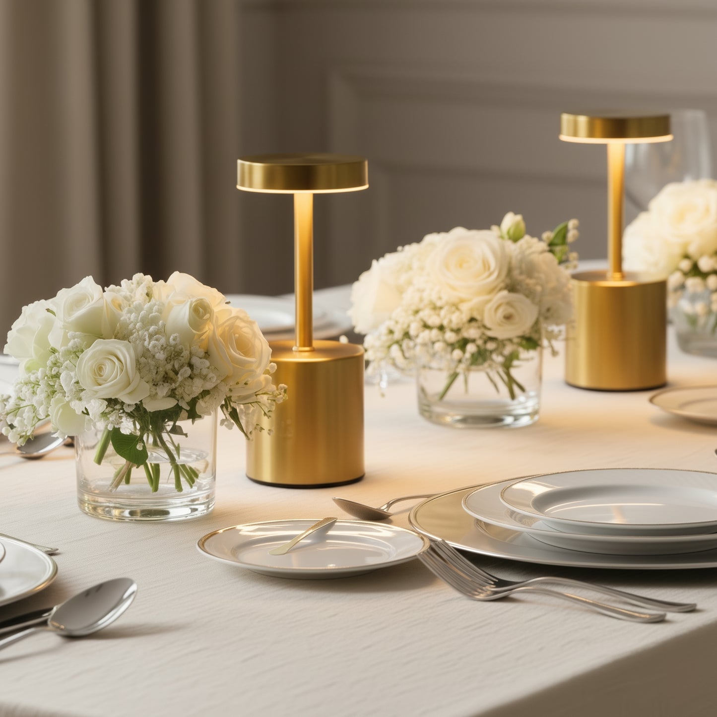 Gold LED table lamp on a dining table with white flowers and elegant dinnerware.