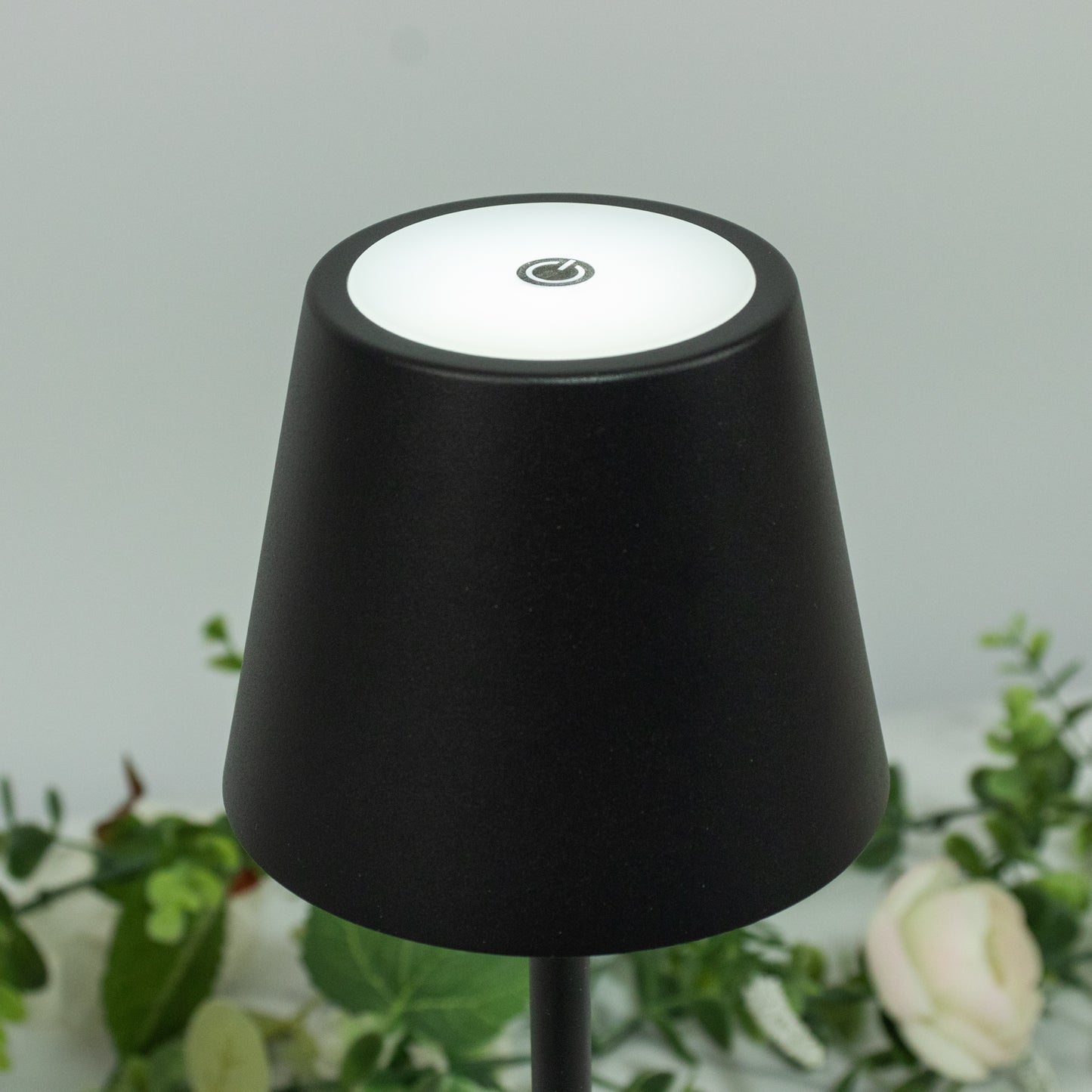 Black cordless table lamp with fluted acrylic shade and touch control.