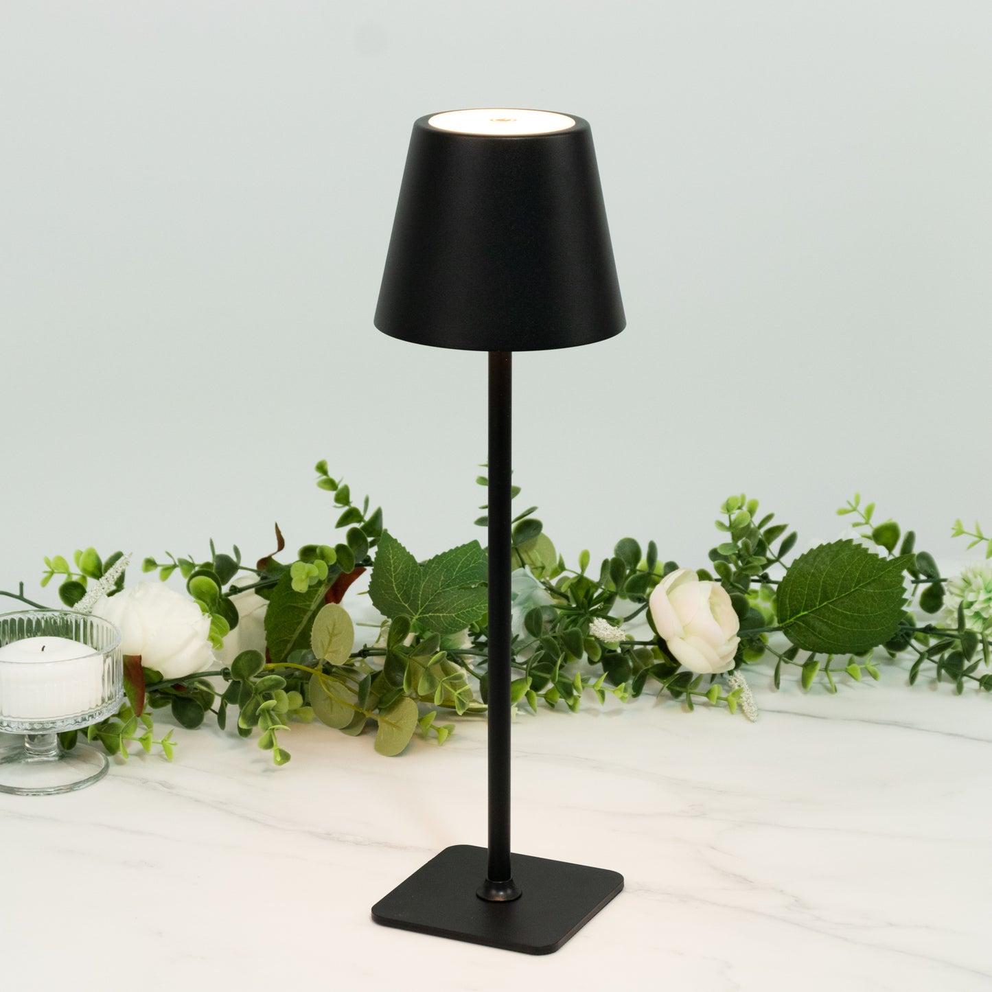 Black cordless metal table lamp with fluted shade, rechargeable and dimmable.