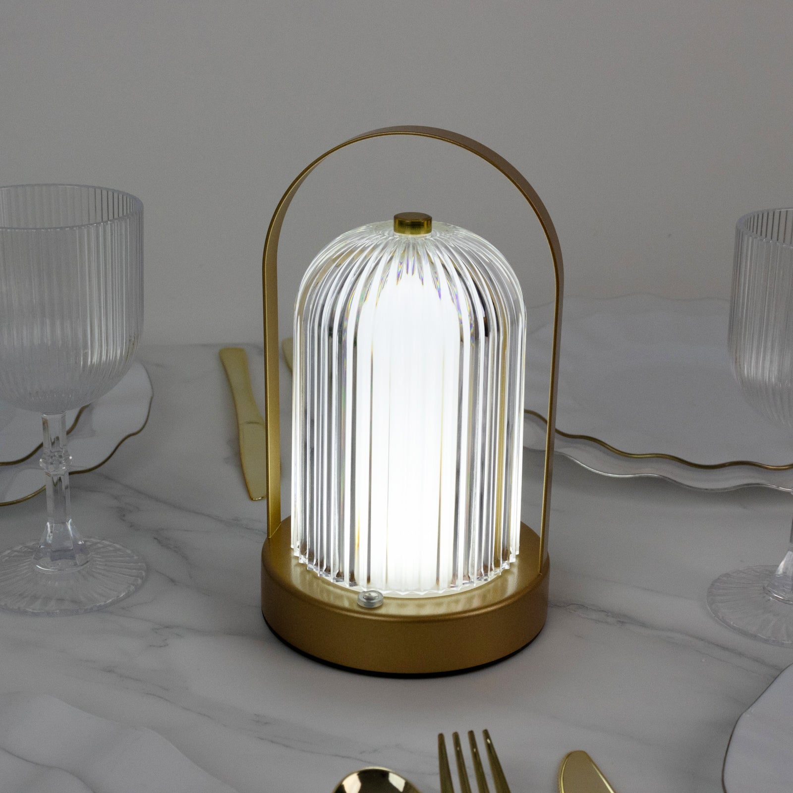 Gold LED table lamp with ribbed acrylic shade and touch control.
