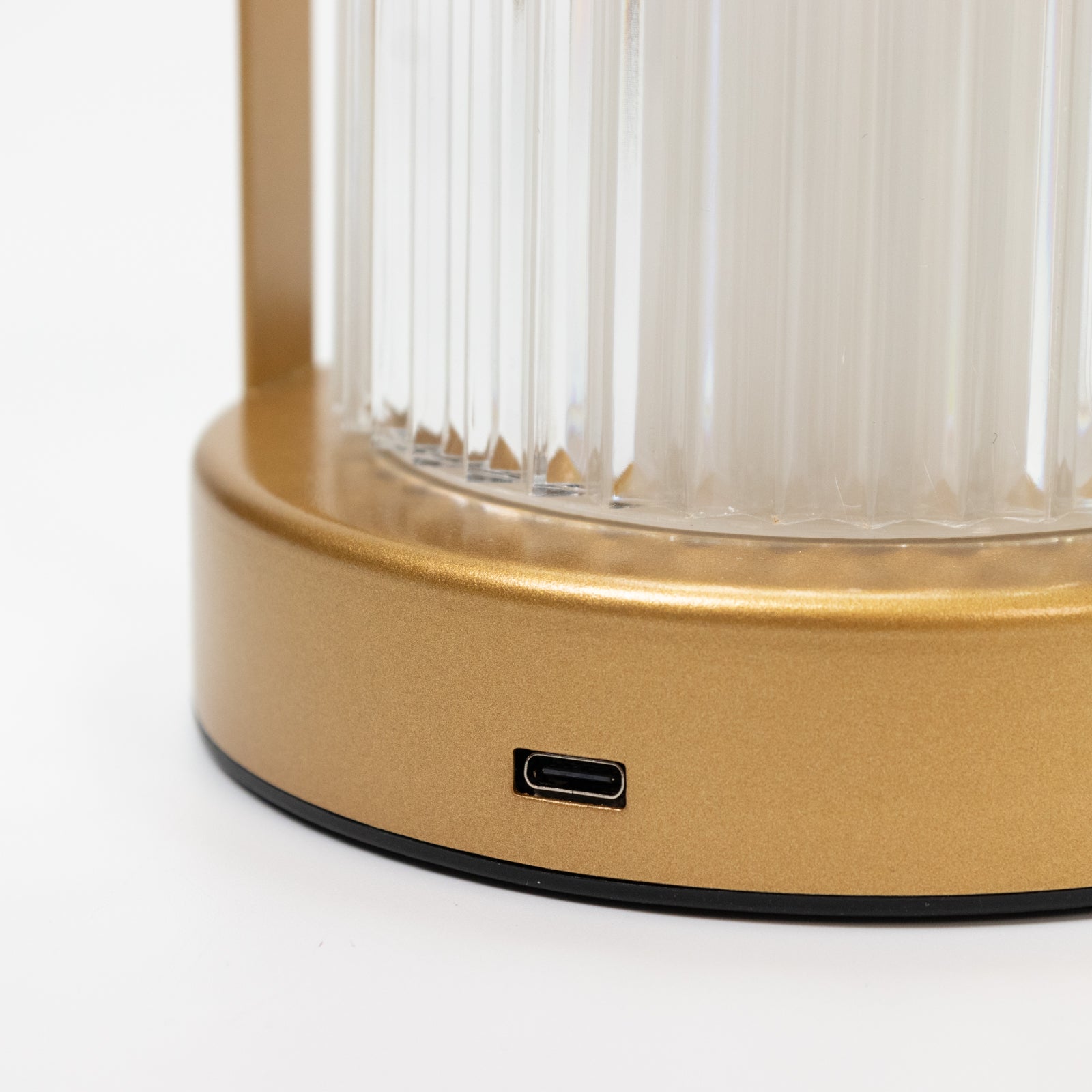 Gold metal LED table lamp with ribbed acrylic shade and USB charging port.