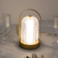 Gold metal LED table lamp with ribbed acrylic shade, cordless and touch control.