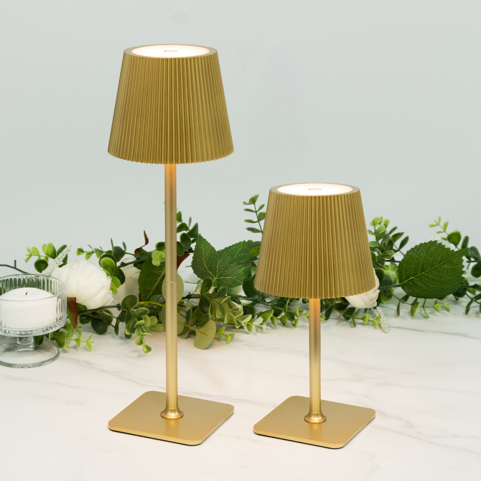 Gold cordless LED table lamp with ribbed shade, adjustable height, and touch control.