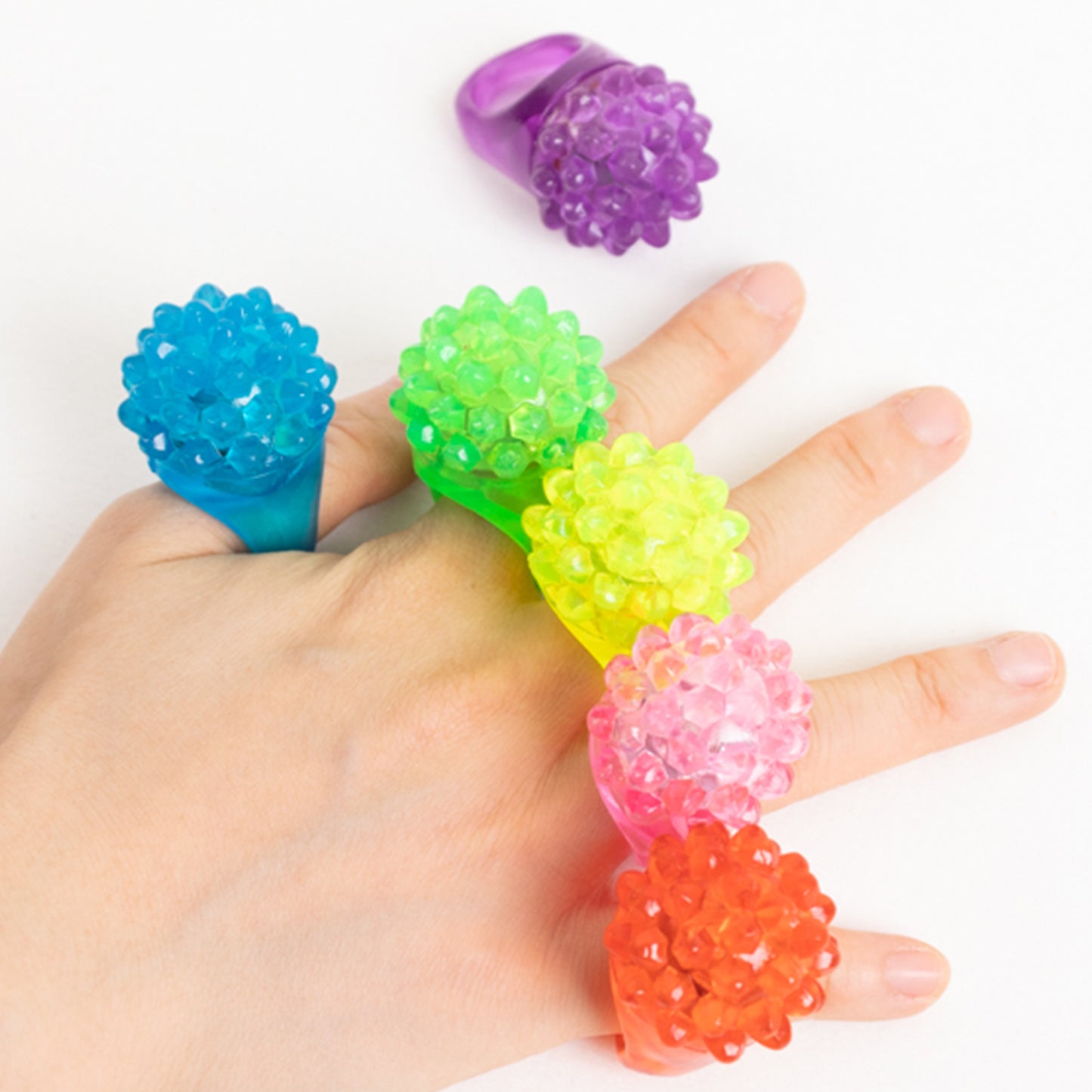 Colorful LED light-up rings in various shades for parties and events.