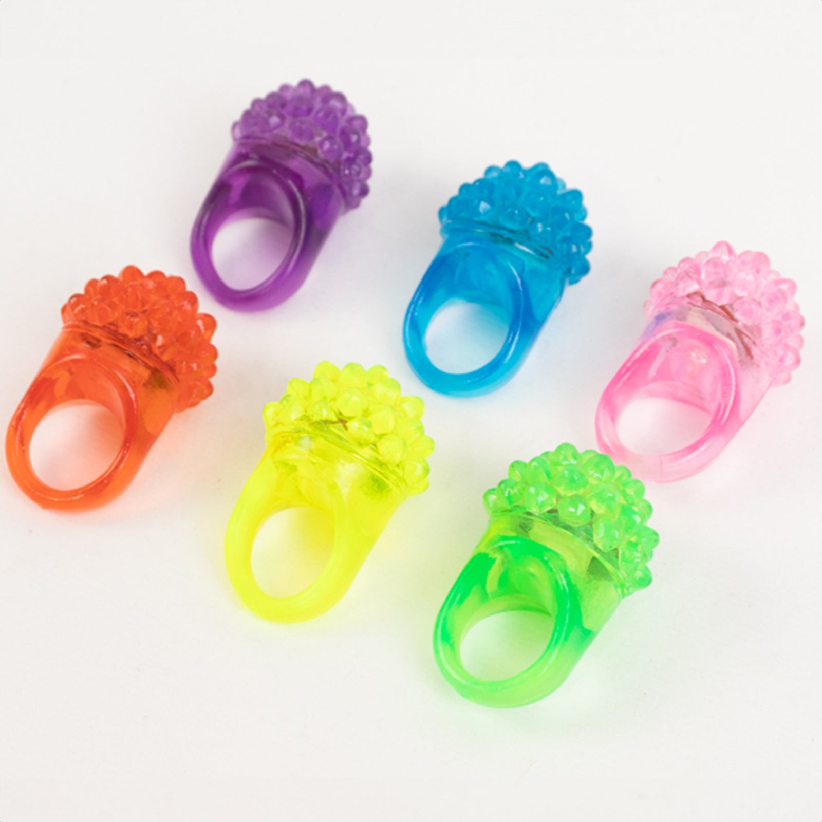Colorful LED light-up rings in various shades for parties and events.