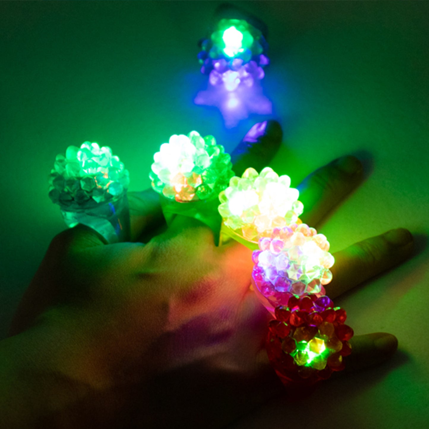 Colorful LED light-up rings on a hand, perfect for parties and events.