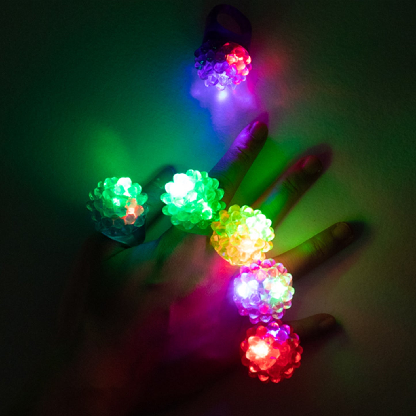 Colorful LED light-up rings on a hand, flashing in various vibrant hues.