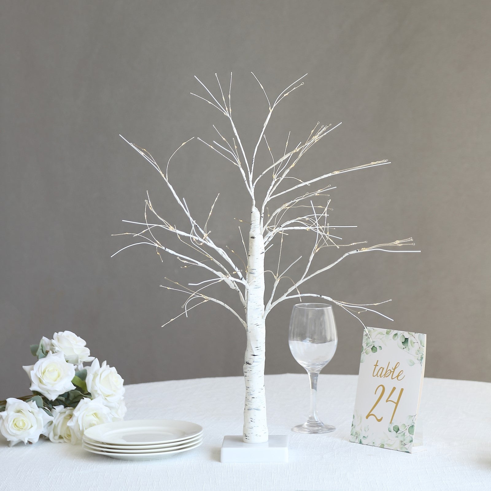 White artificial LED birch tree lamp centerpiece with warm white lights.