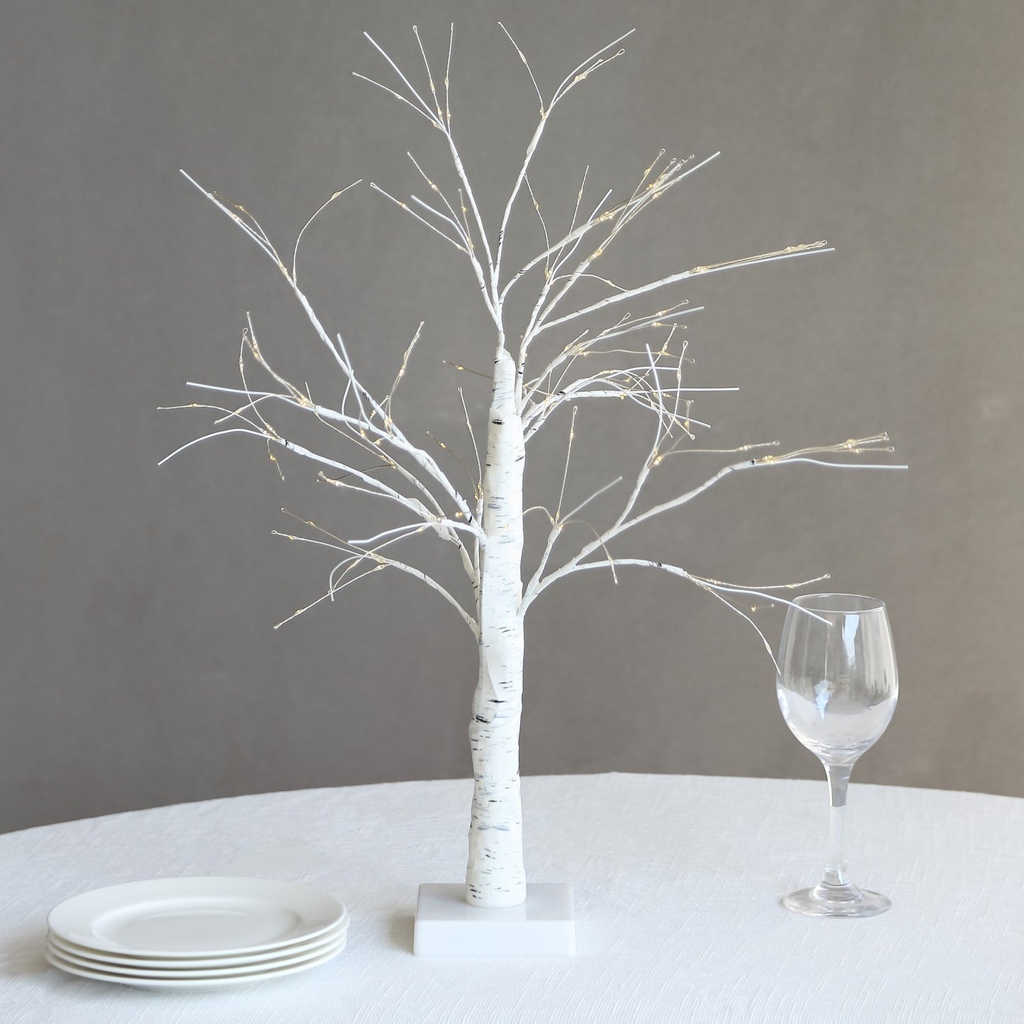 2ft white artificial LED birch tree lamp with warm white lights.
