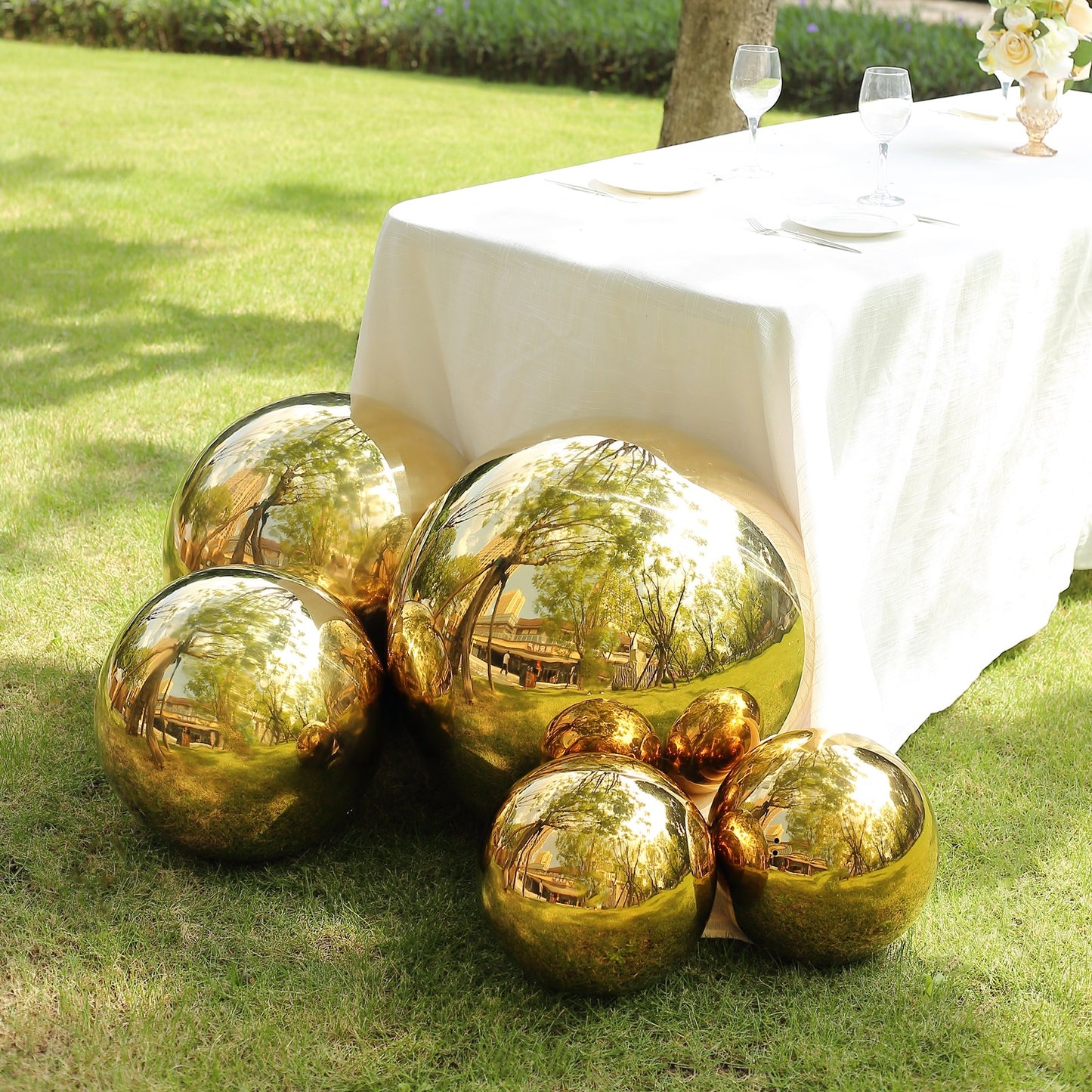 Gold reflective garden globe sphere, shiny mirror finish.