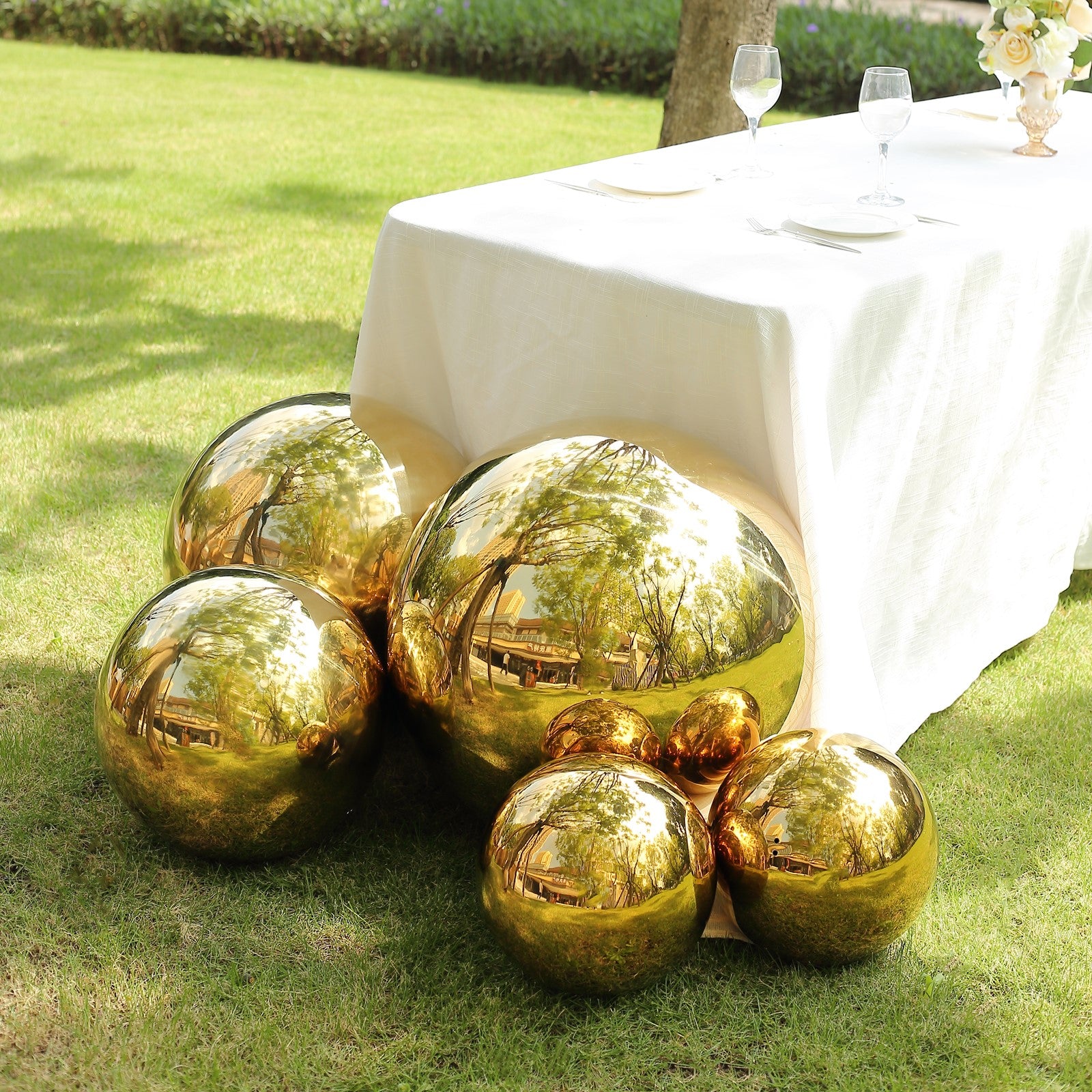 Gold reflective garden globe sphere, shiny mirror finish.
