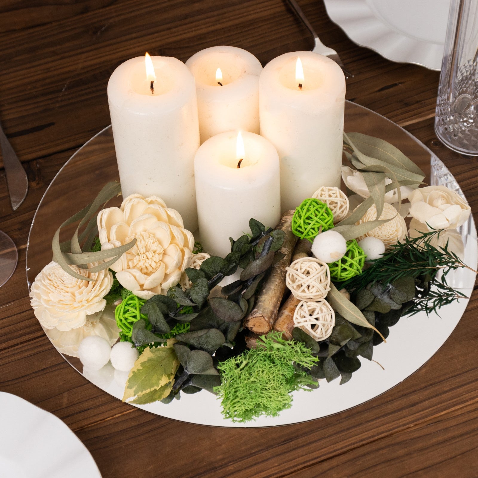 Natural dried assorted potpourri in green and cream with candles.