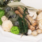 Natural dried assorted potpourri bowl with green and beige elements.