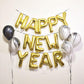 Matte gold letter and number balloons spelling "Happy New Year" on display.