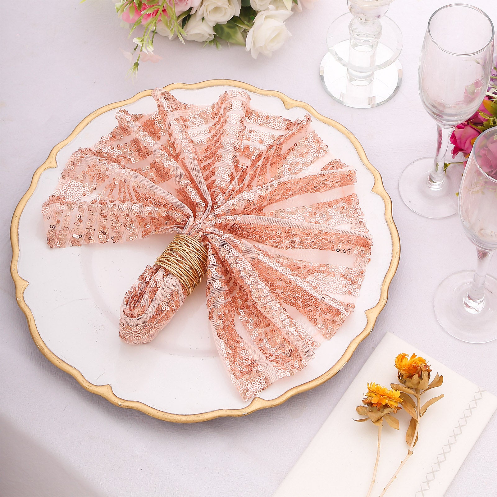 Blush sequin cloth napkin elegantly arranged on a decorative plate.