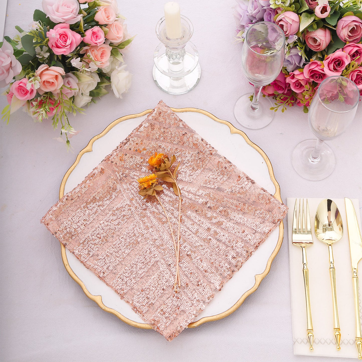 Blush geometric diamond glitz sequin cloth napkin on a decorative dinner plate.