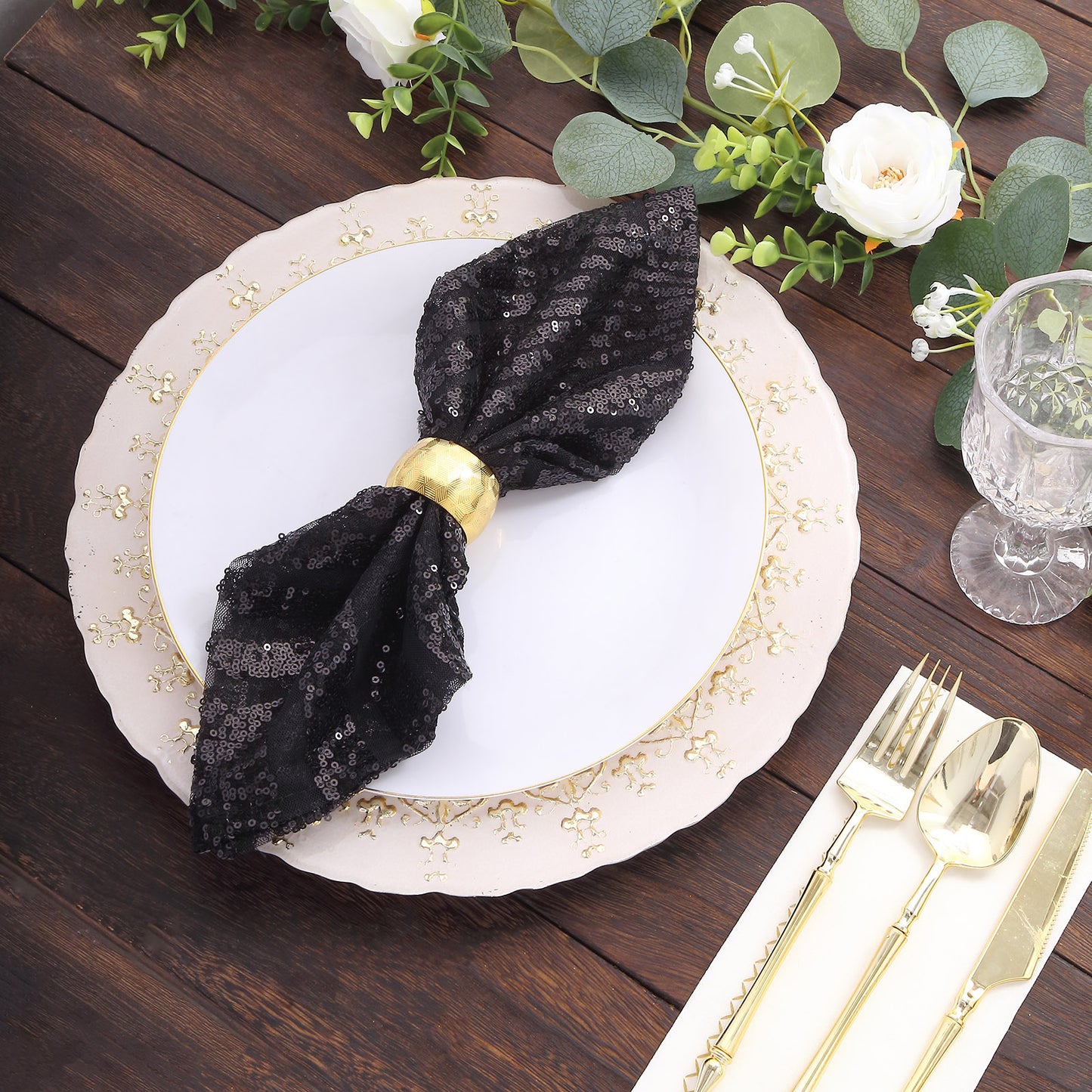 Black geometric diamond glitz sequin cloth napkin on a decorative table setting.