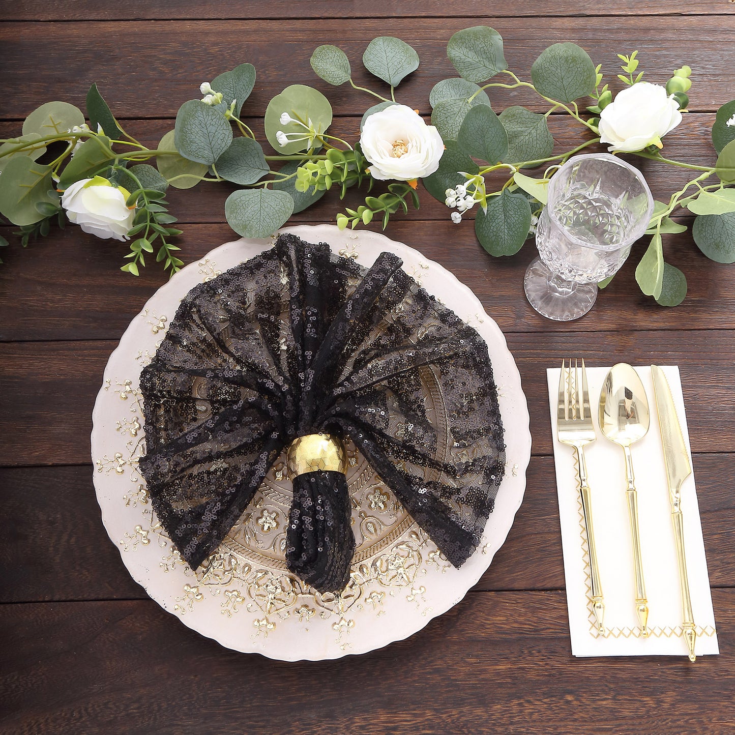 Black geometric diamond glitz sequin cloth napkin on elegant table setting.