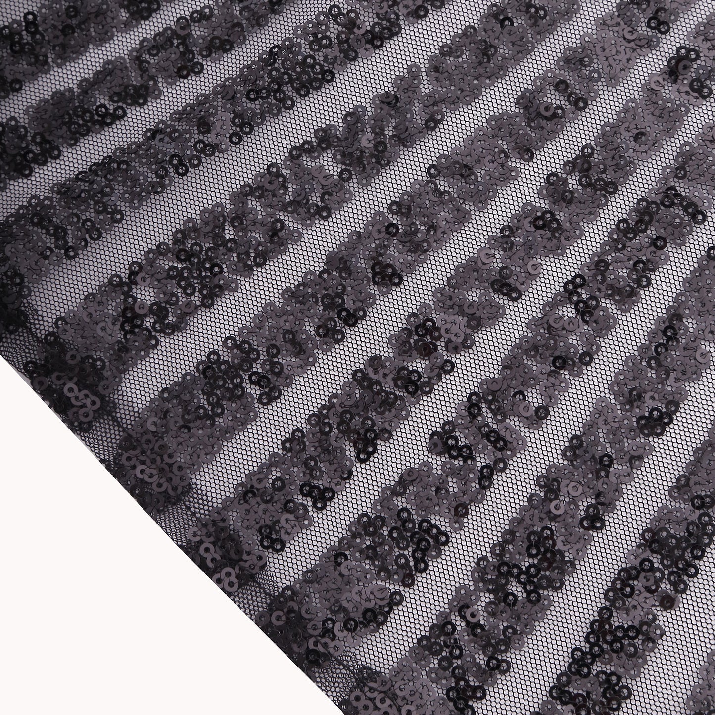 Black sequin cloth napkin with geometric diamond pattern.