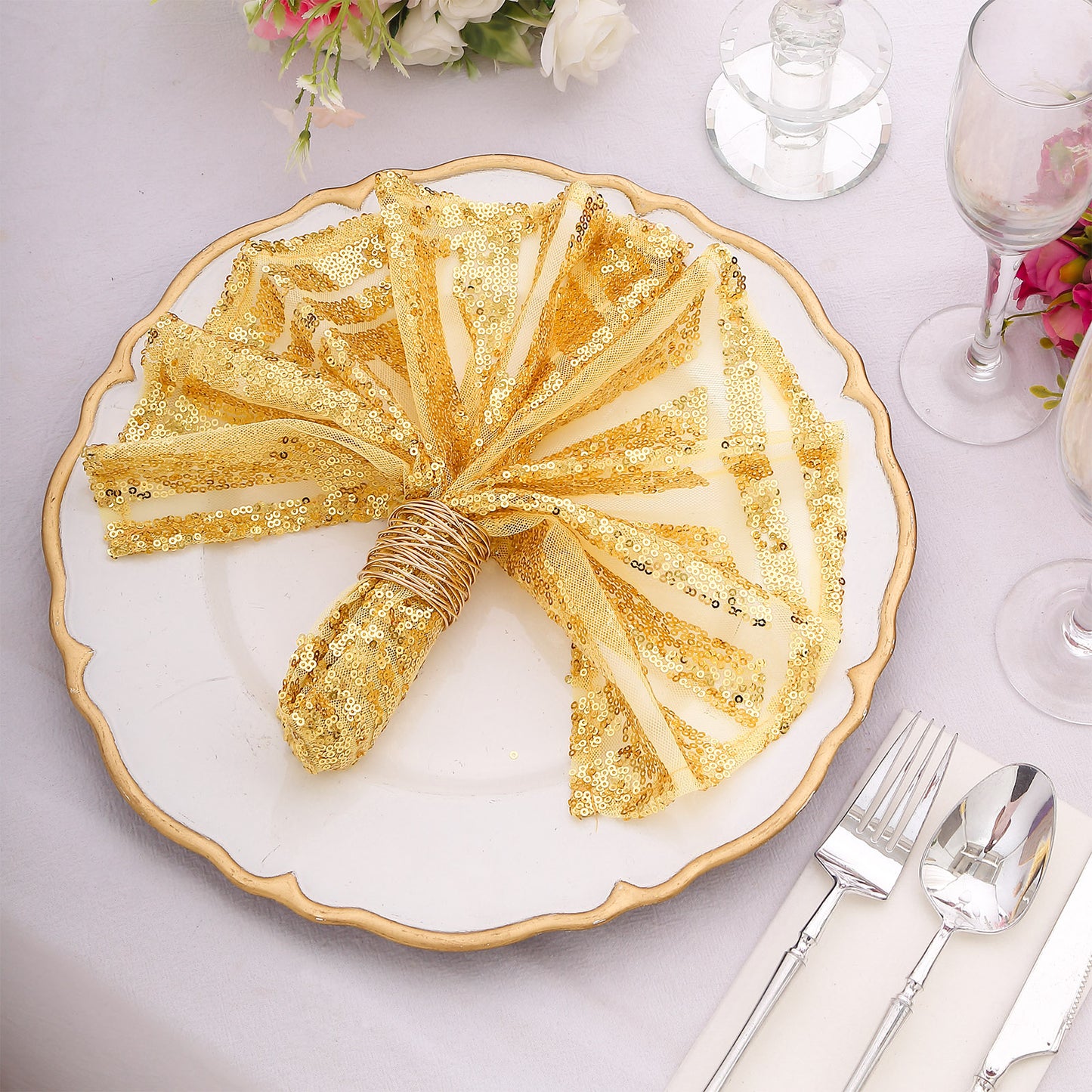 Gold geometric diamond glitz sequin cloth napkins on a dinner plate.