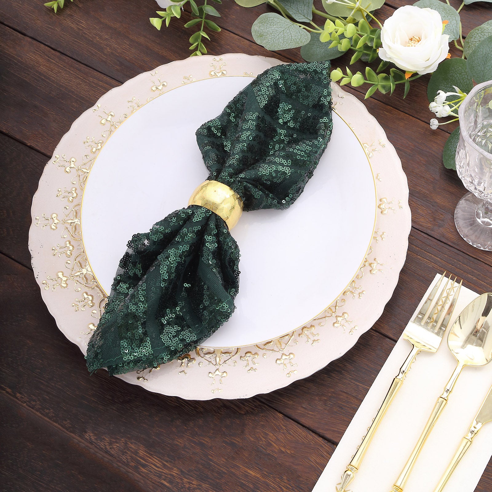 Emerald green geometric diamond glitz sequin cloth napkin on a decorative table setting.