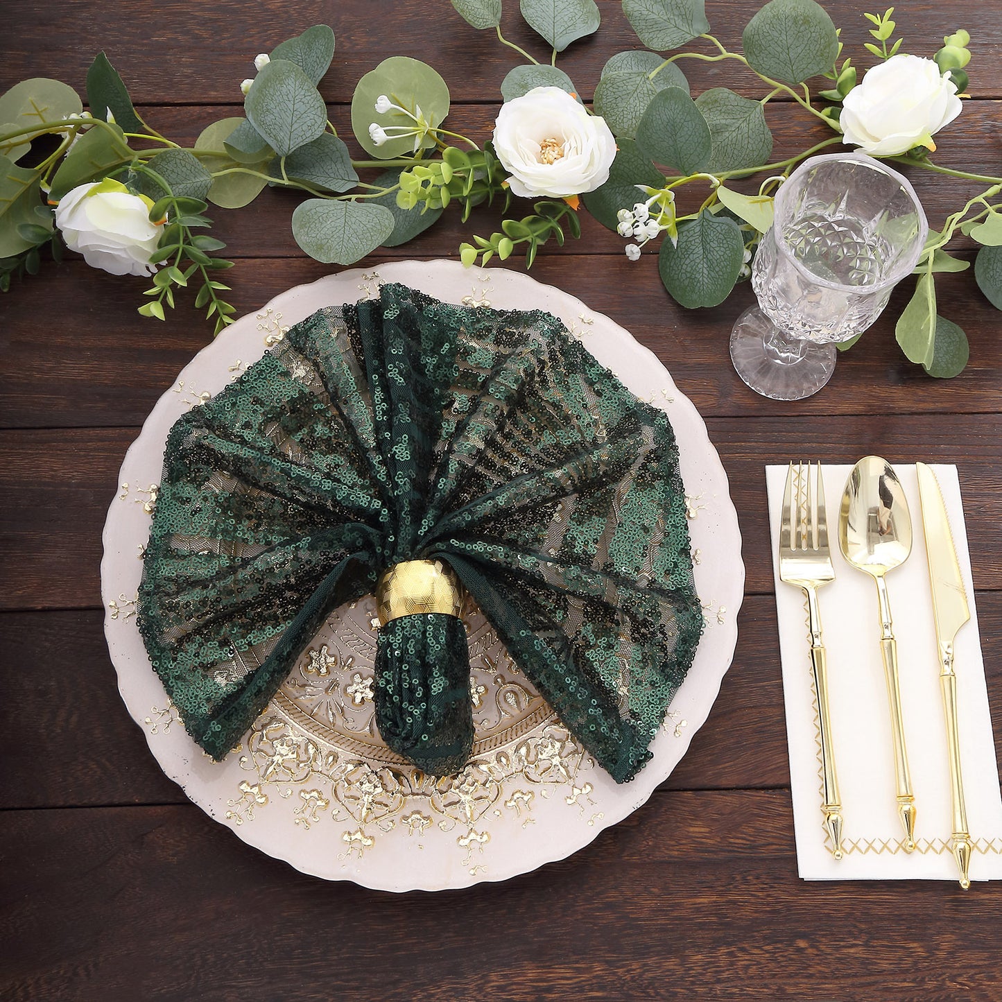 Emerald green geometric diamond glitz sequin cloth napkin on a decorative table setting.