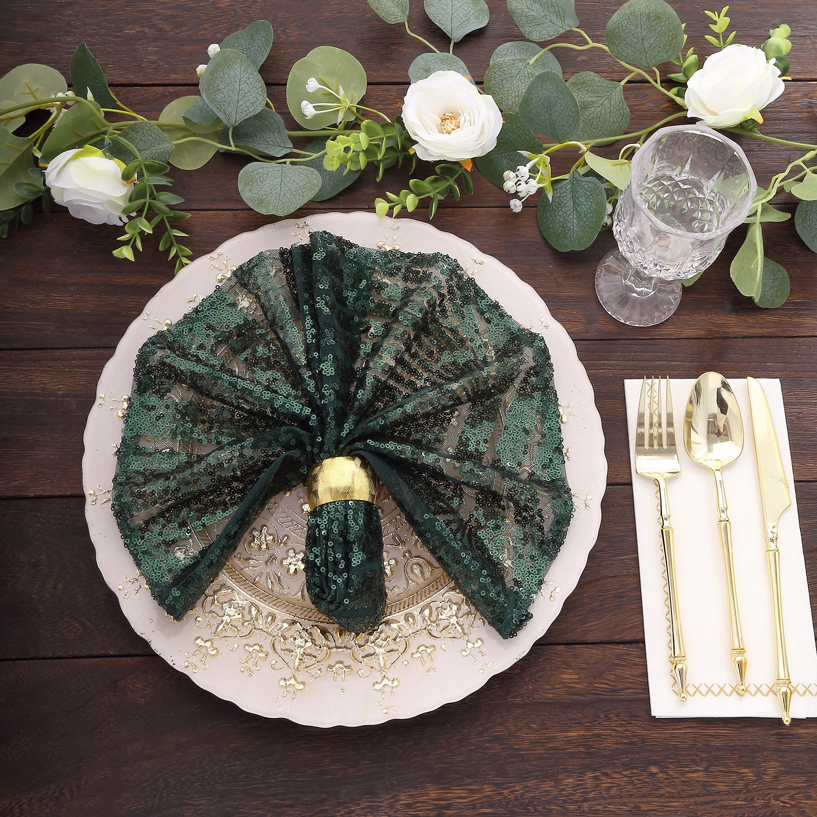 Emerald green geometric diamond glitz sequin cloth napkin on a decorative table setting.