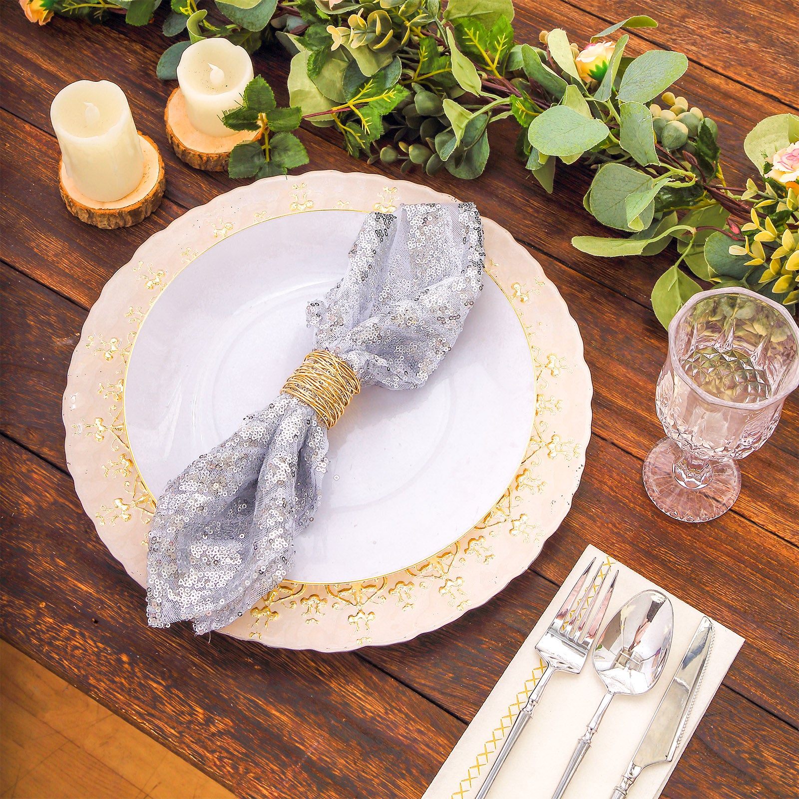 Silver geometric diamond sequin cloth napkins on a decorative dinner setting.