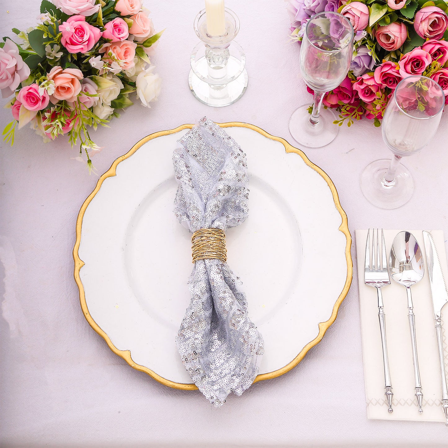 Silver geometric sequin napkin on an elegant dinner plate.