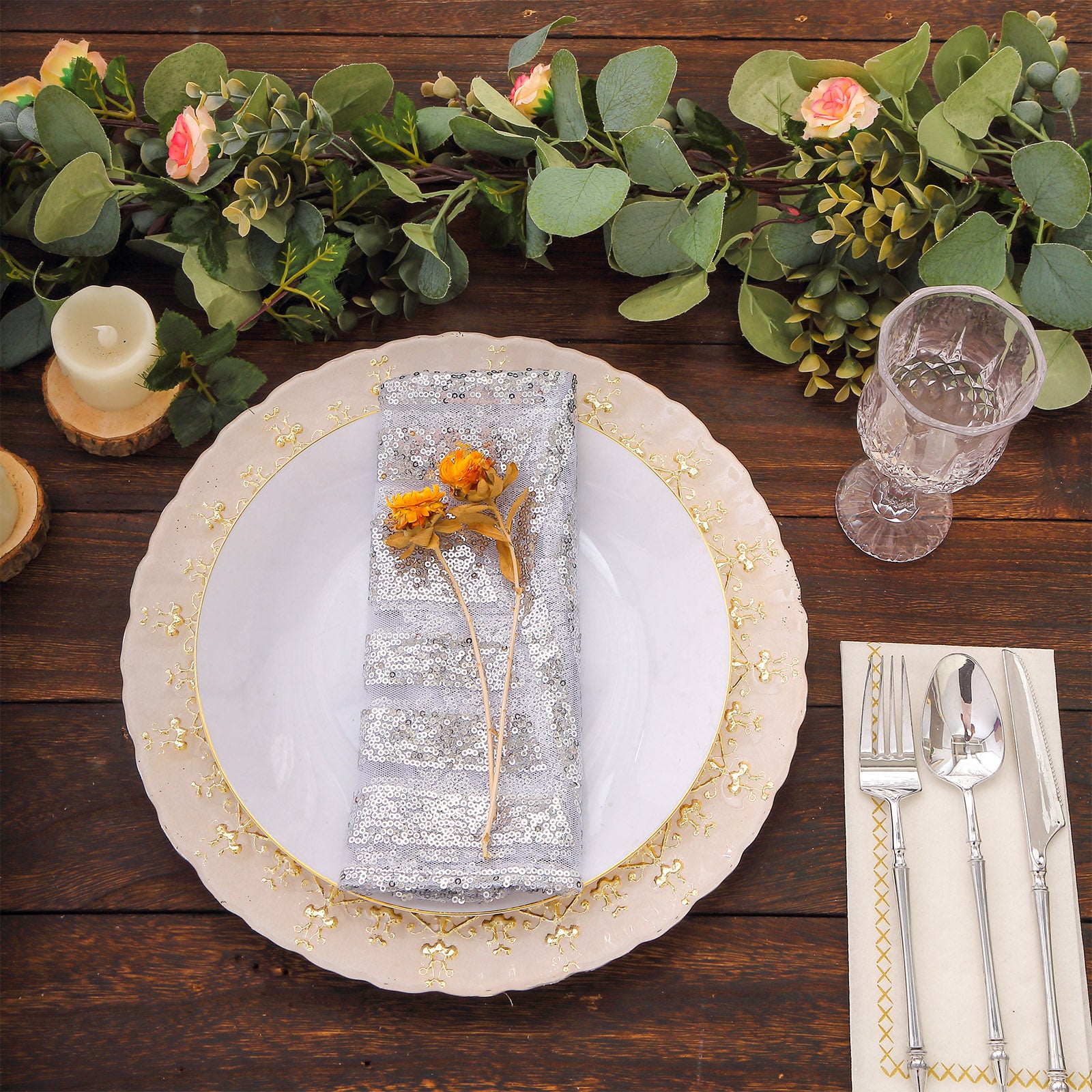 Silver geometric sequin cloth napkin on a decorative dinner plate.