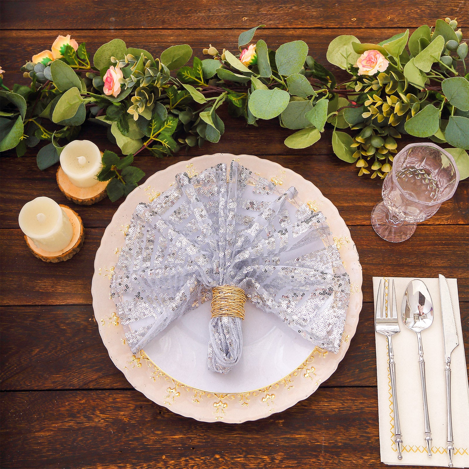 Silver geometric diamond glitz sequin cloth napkin on a decorative dinner plate.