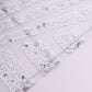 Silver sequin cloth napkins with geometric diamond pattern.