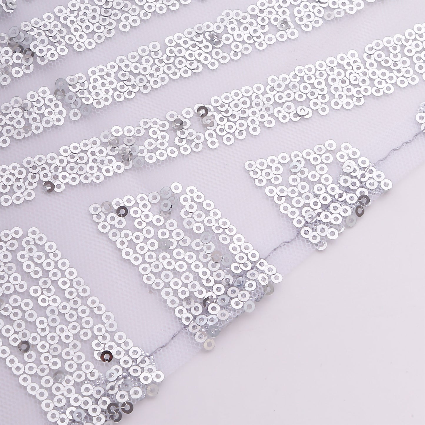 Silver sequin cloth napkins with geometric diamond pattern.