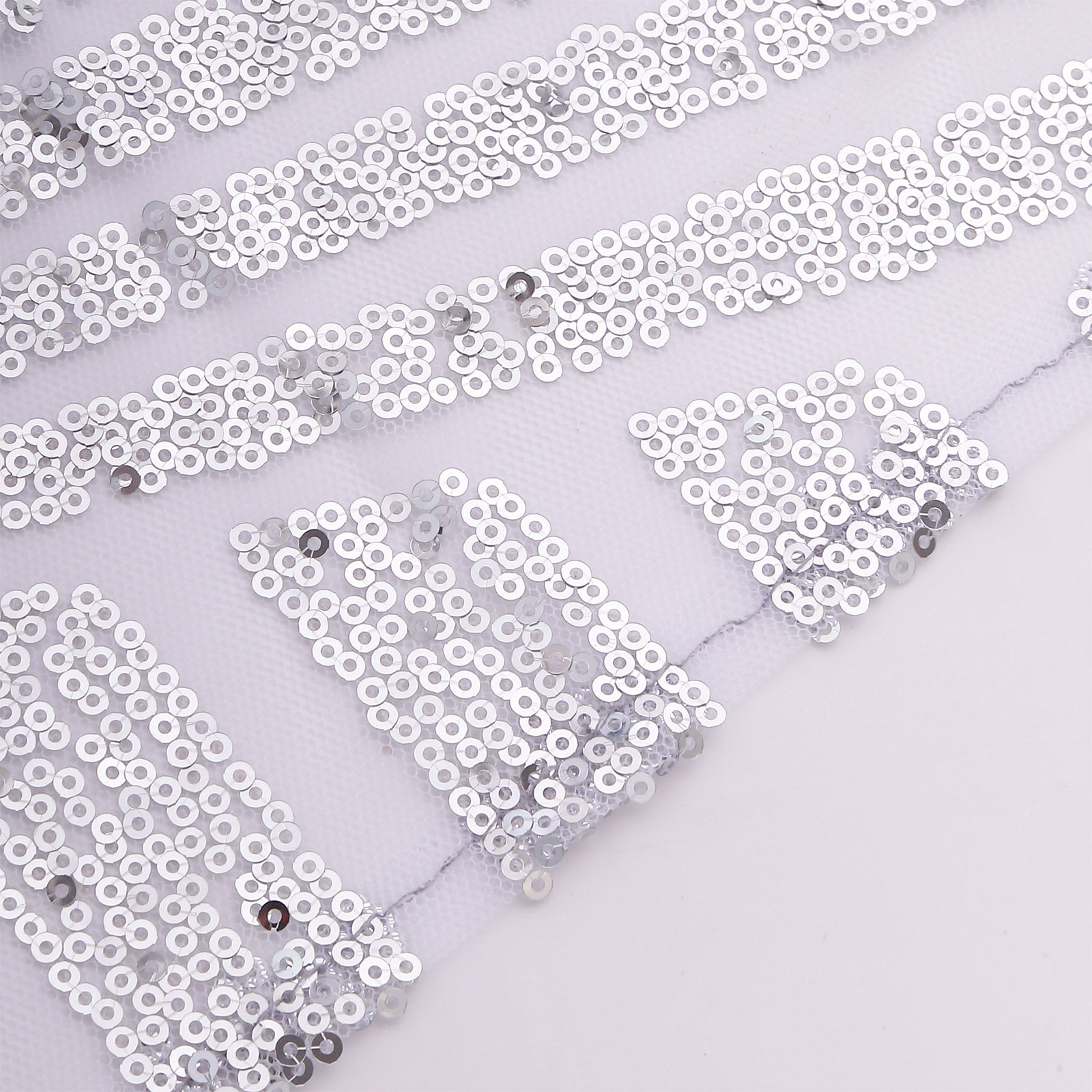 Silver sequin cloth napkins with geometric diamond pattern.