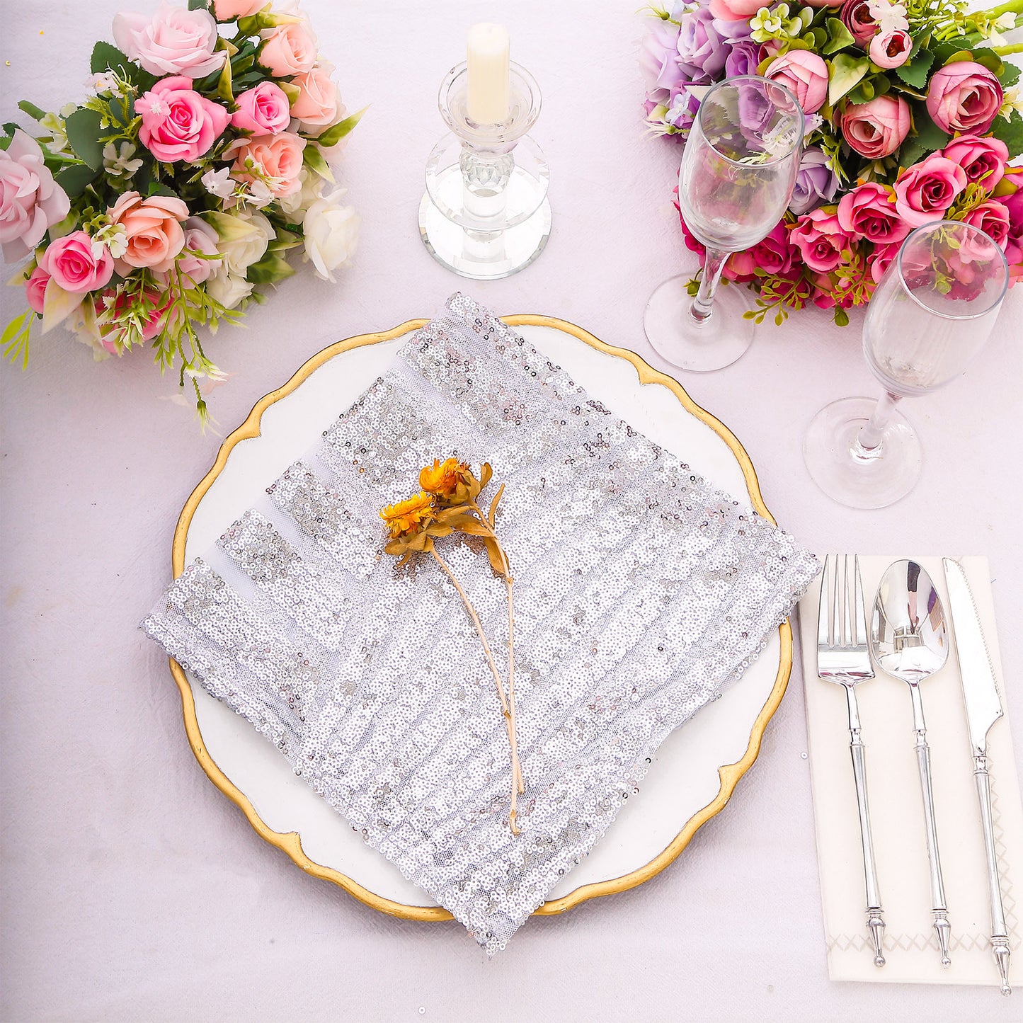 Silver geometric diamond glitz sequin cloth napkin on a decorative dinner table.