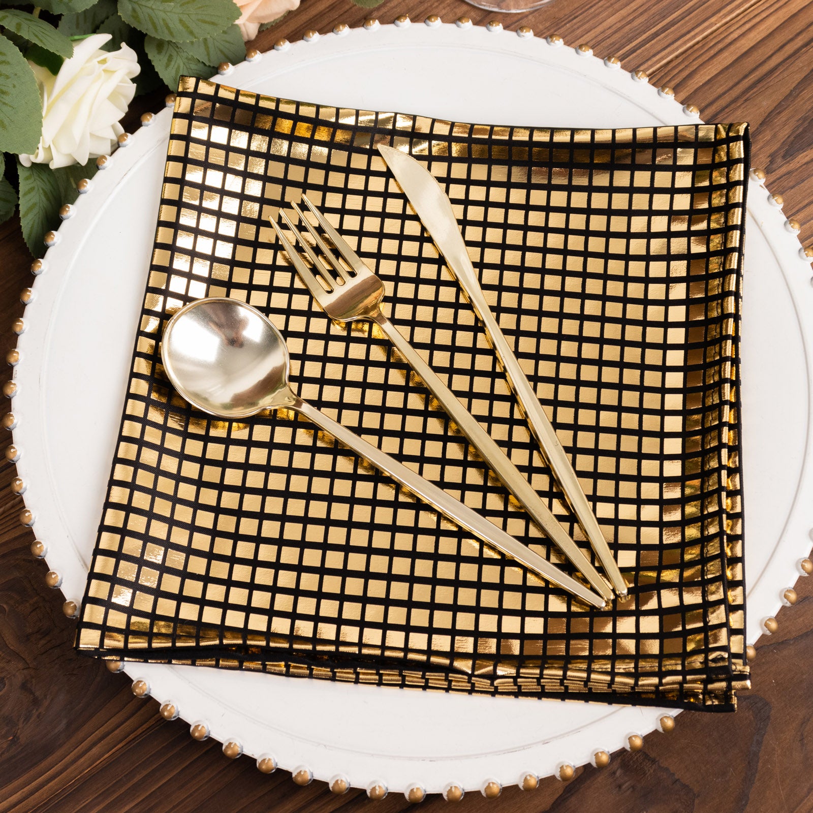 Shiny black and gold foil dinner napkins for disco-themed table settings.