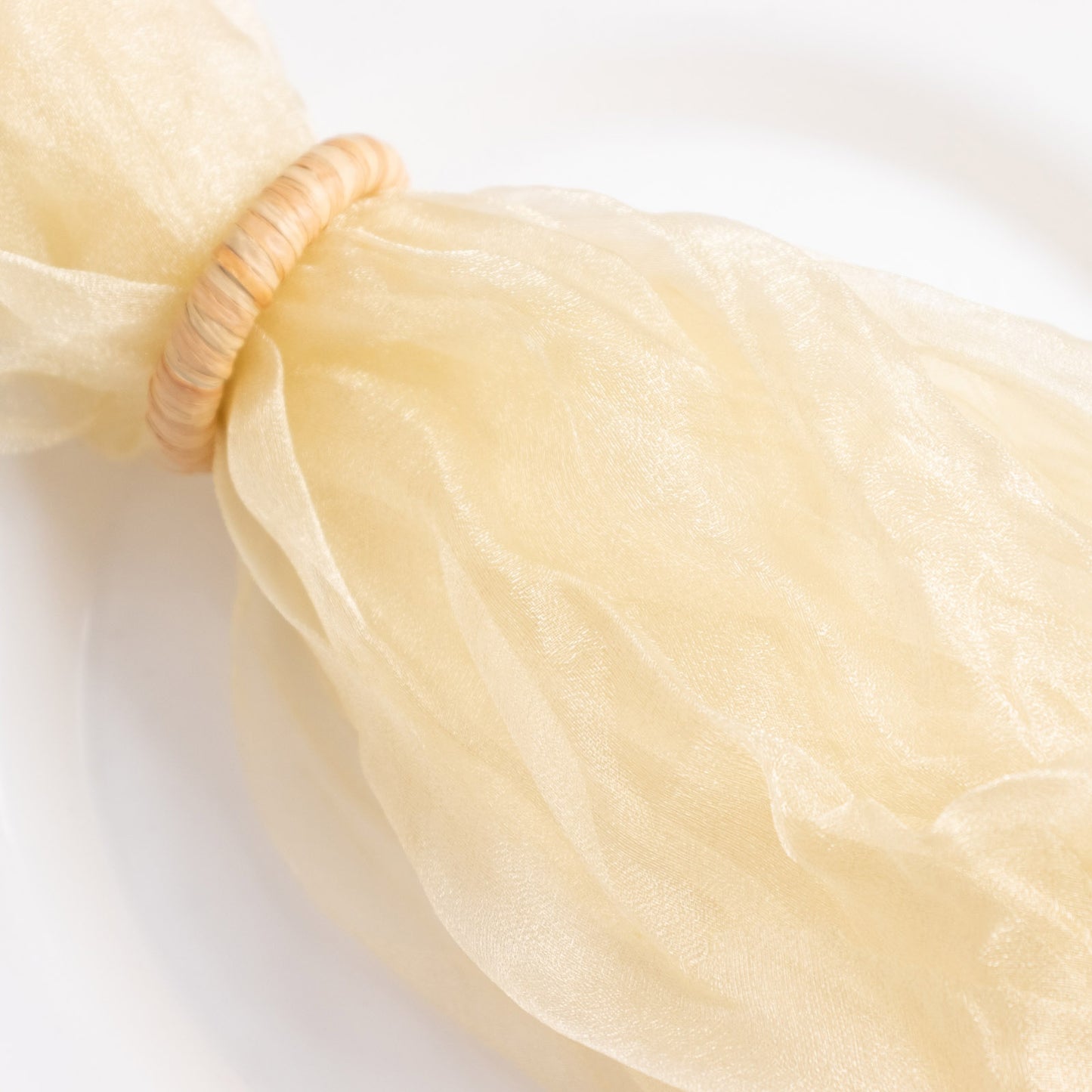 Champagne sheer crinkled organza dinner napkin with decorative shimmer.