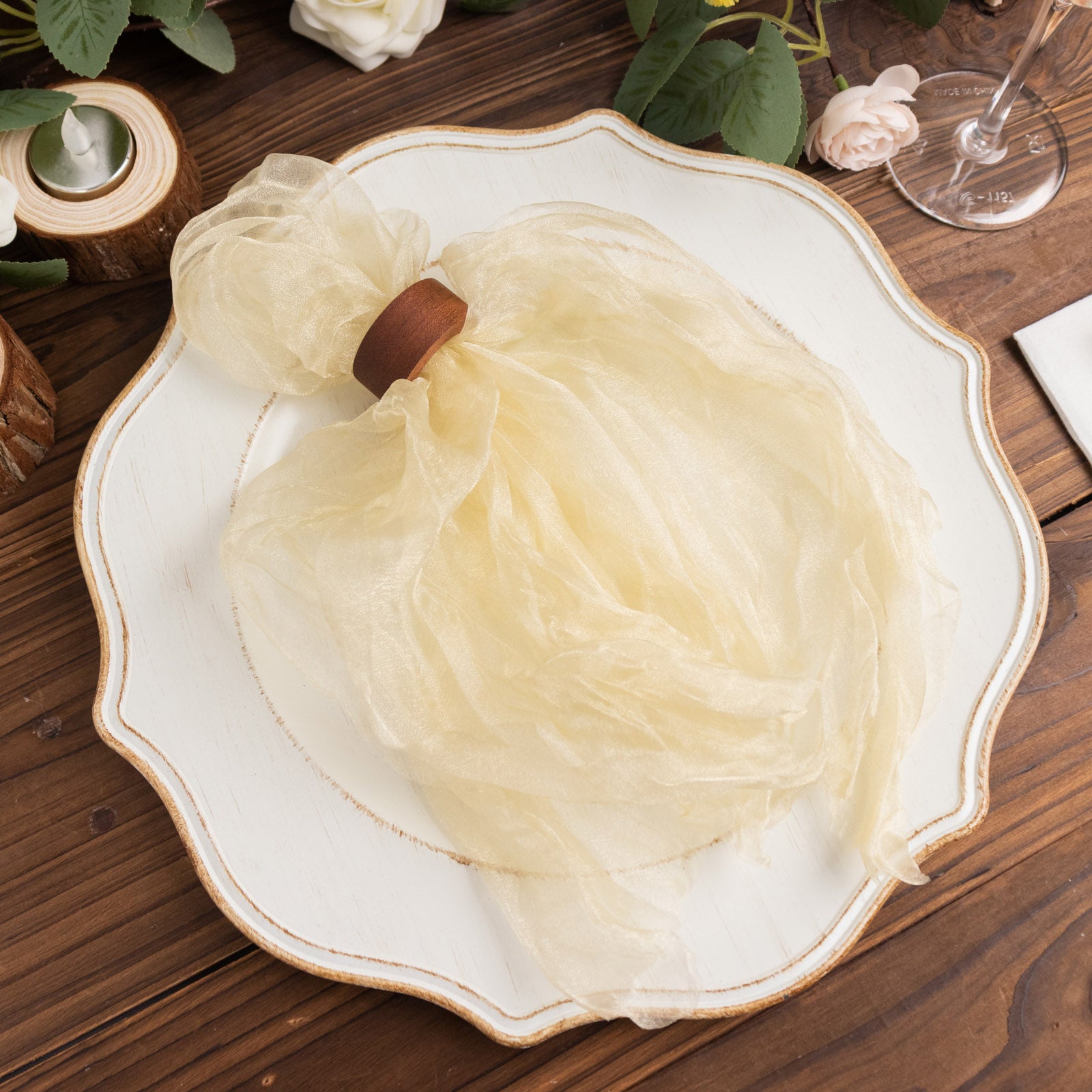 Champagne sheer crinkled organza napkins on a decorative plate.
