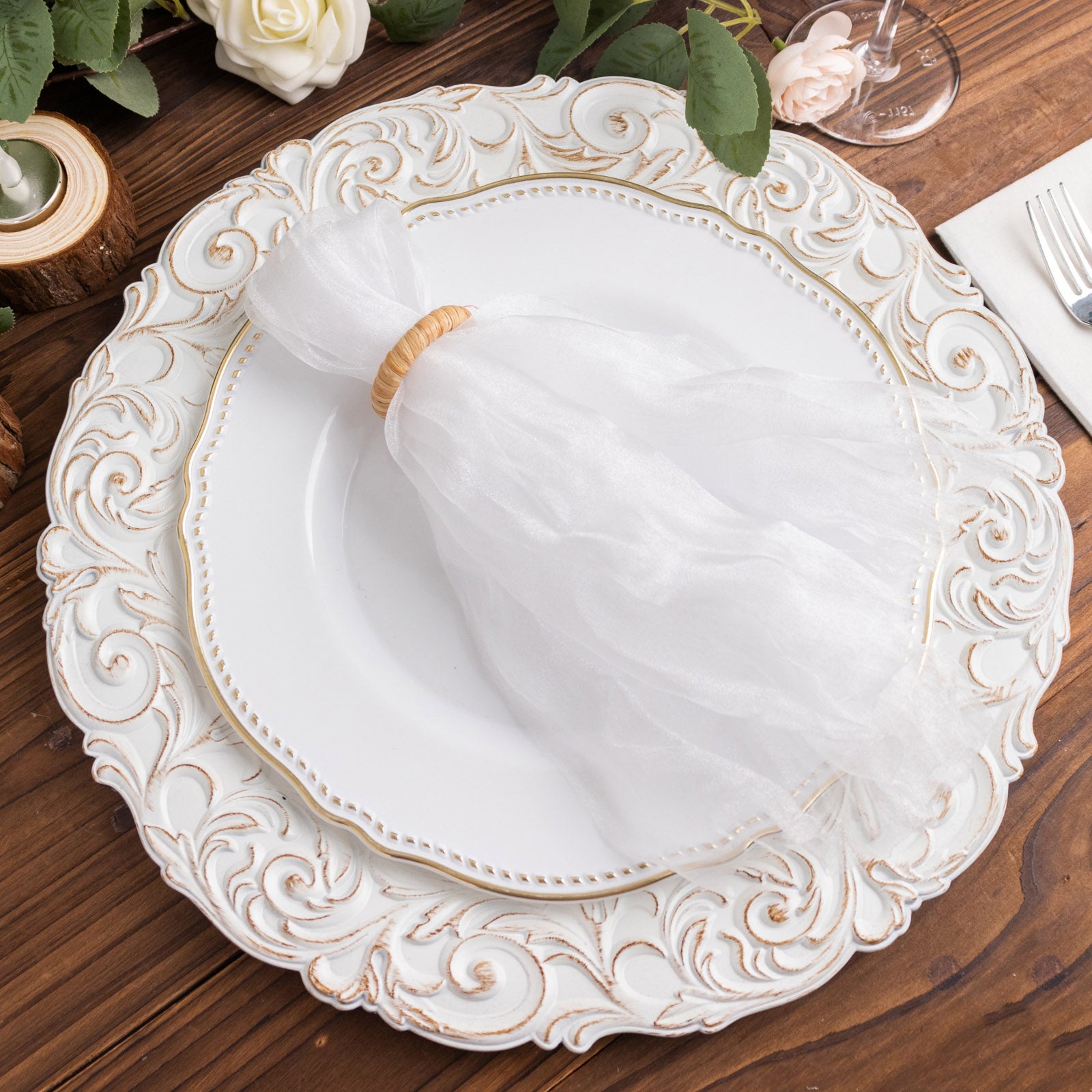 White sheer crinkled organza dinner napkins on an elegant plate.
