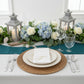 White napkin with gold foil monogram "F" on a decorative table setting.